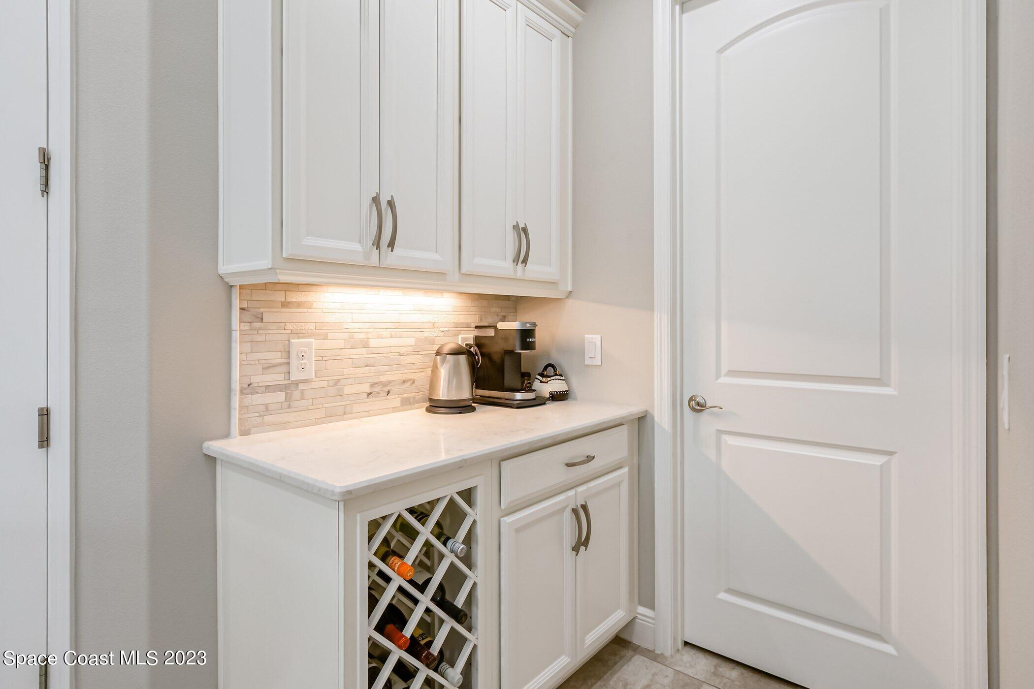 7729 Kerrington Drive Melbourne, FL 32940 - Photo 37 of 61 a kitchen with white cabinets and sink