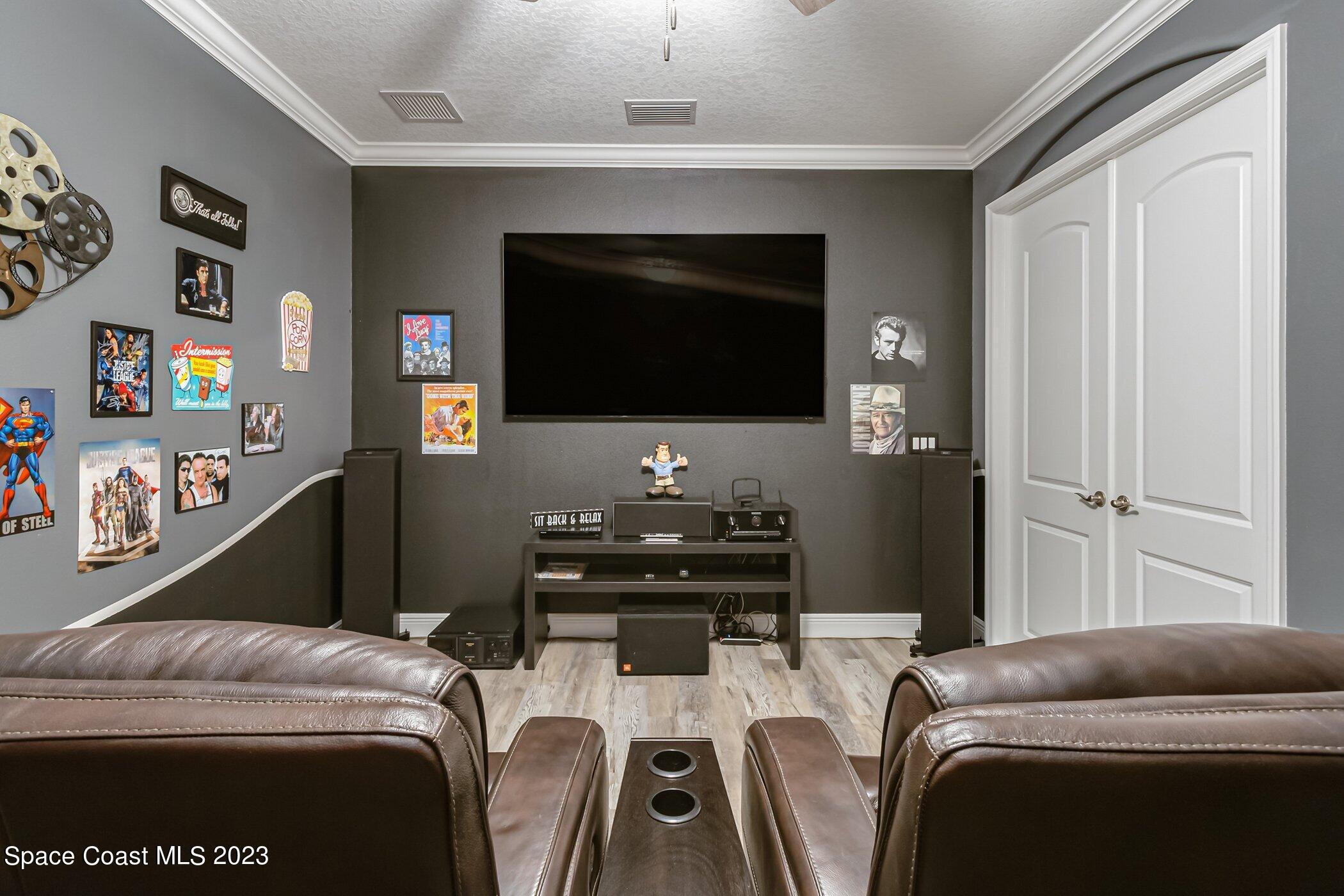 7729 Kerrington Drive Melbourne, FL 32940 - Photo 40 of 61 a bedroom with a bed and a flat screen tv