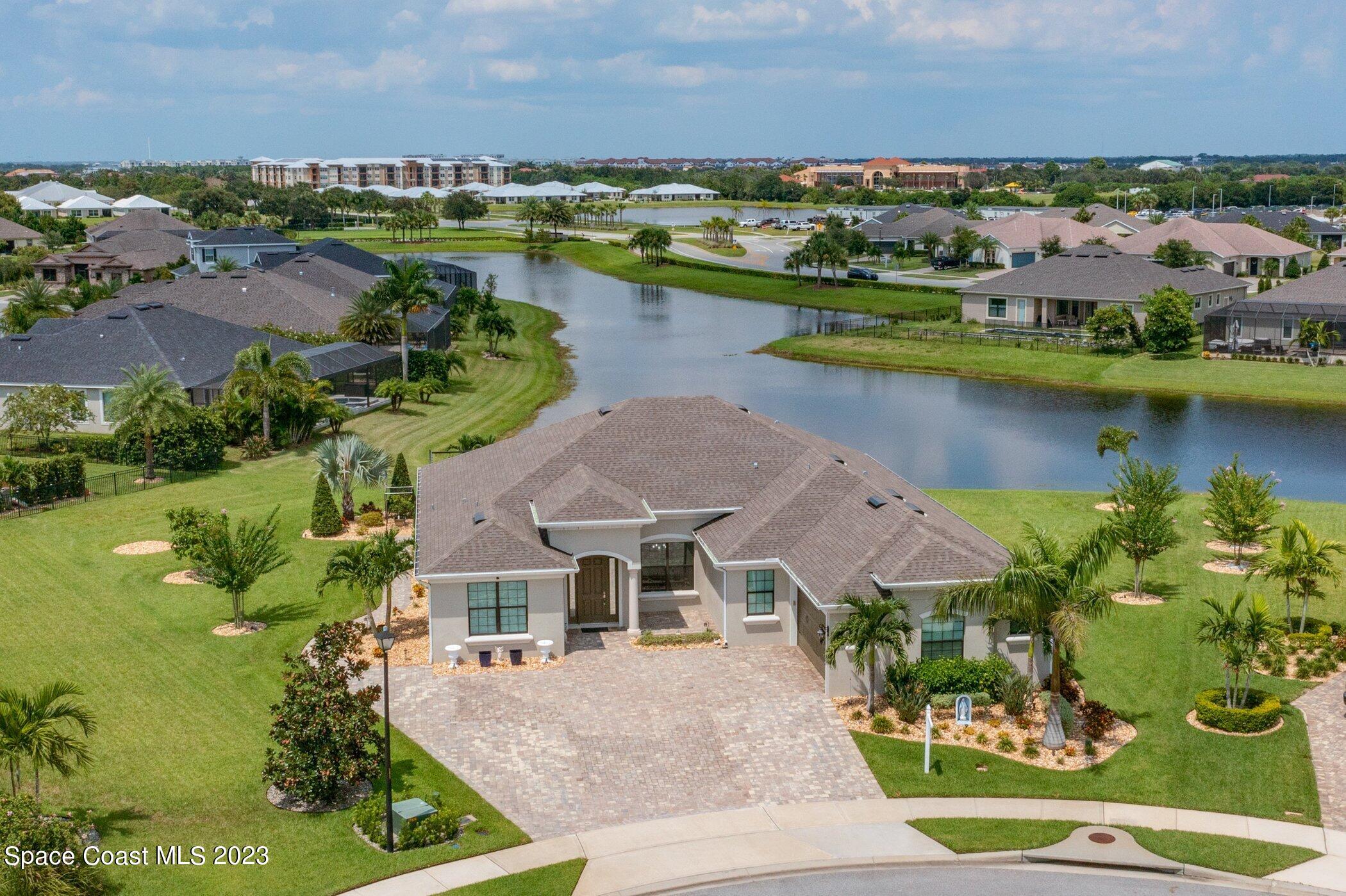 7729 Kerrington Drive Melbourne, FL 32940 - Photo 42 of 61 an aerial view of a house with a lake view