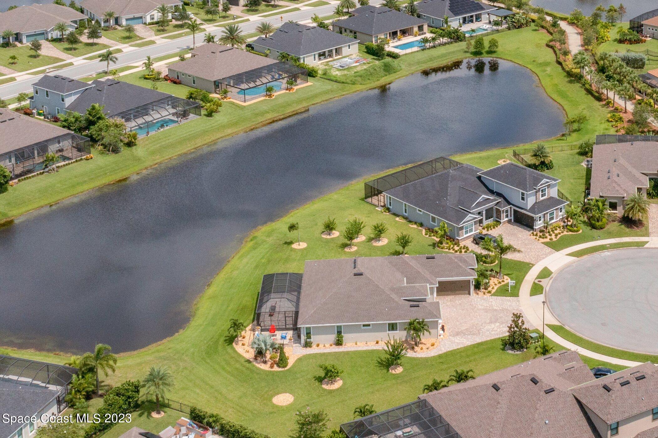 7729 Kerrington Drive Melbourne, FL 32940 - Photo 45 of 61 an aerial view of a house with a swimming pool