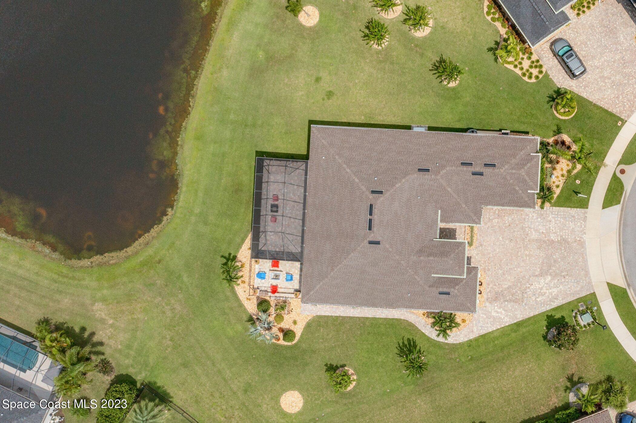 7729 Kerrington Drive Melbourne, FL 32940 - Photo 46 of 61 an aerial view of a house with a swimming pool