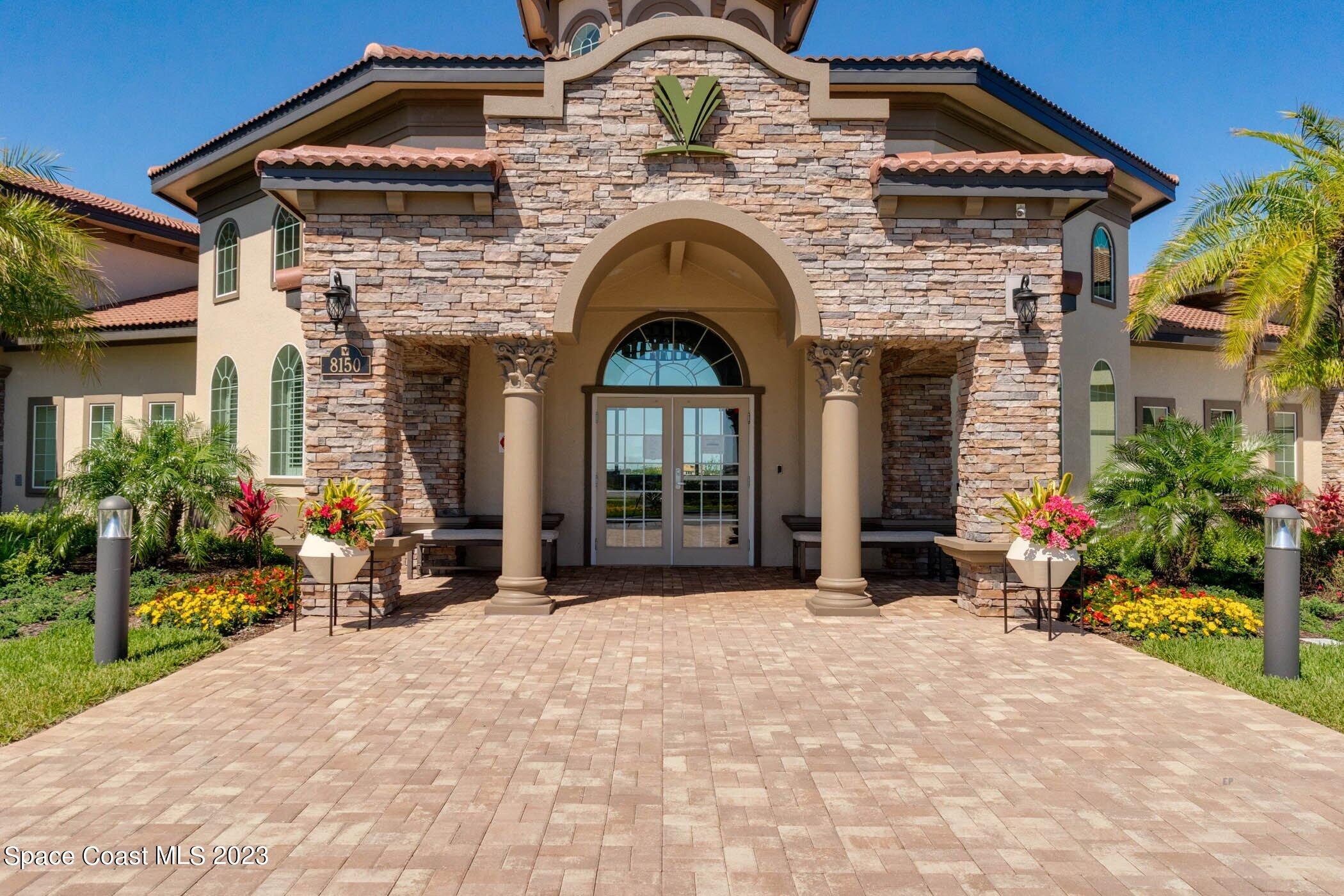 7729 Kerrington Drive Melbourne, FL 32940 - Photo 49 of 61 a front view of a house with a garden