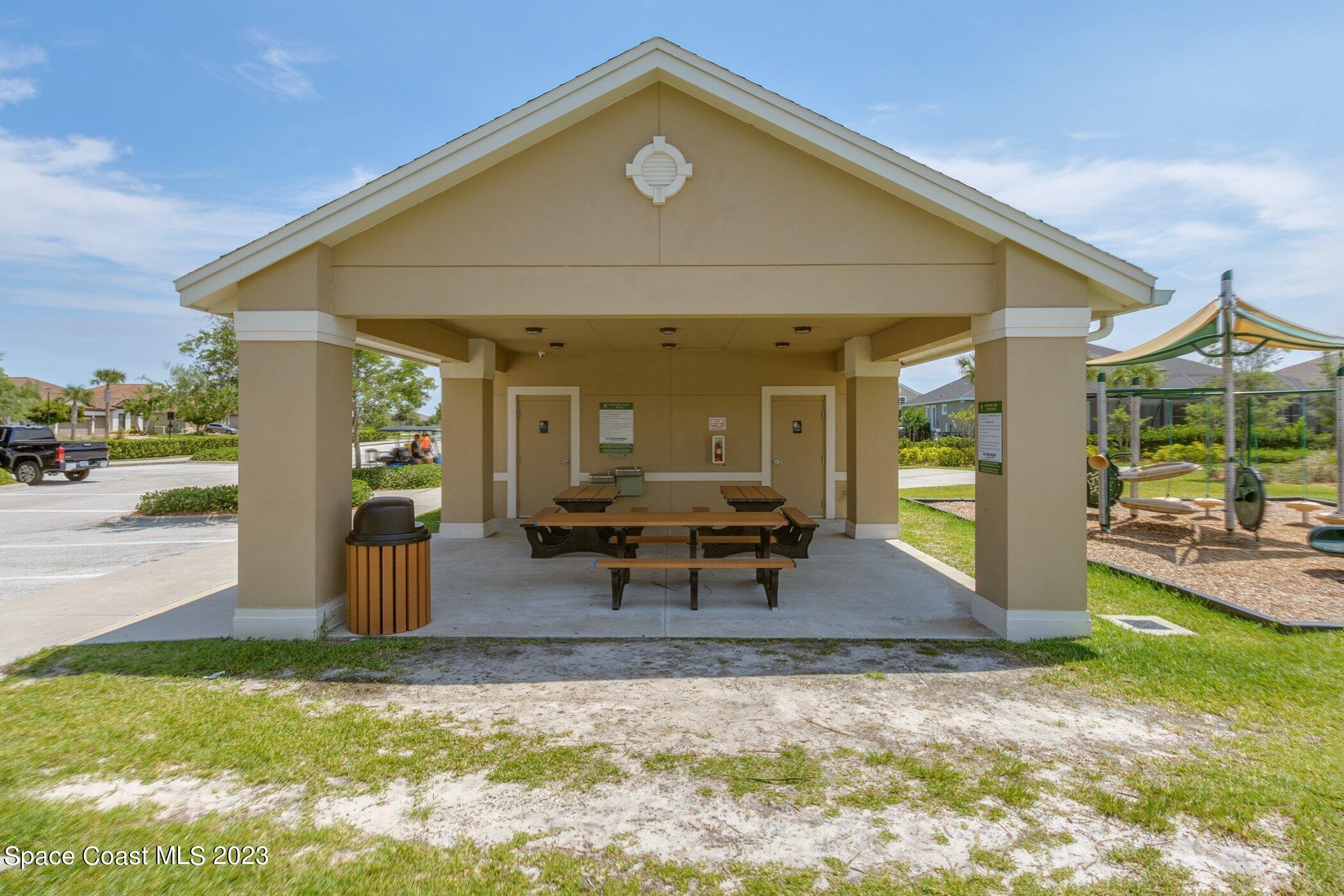 7729 Kerrington Drive Melbourne, FL 32940 - Photo 55 of 61 a view of a house with backyard porch and sitting area