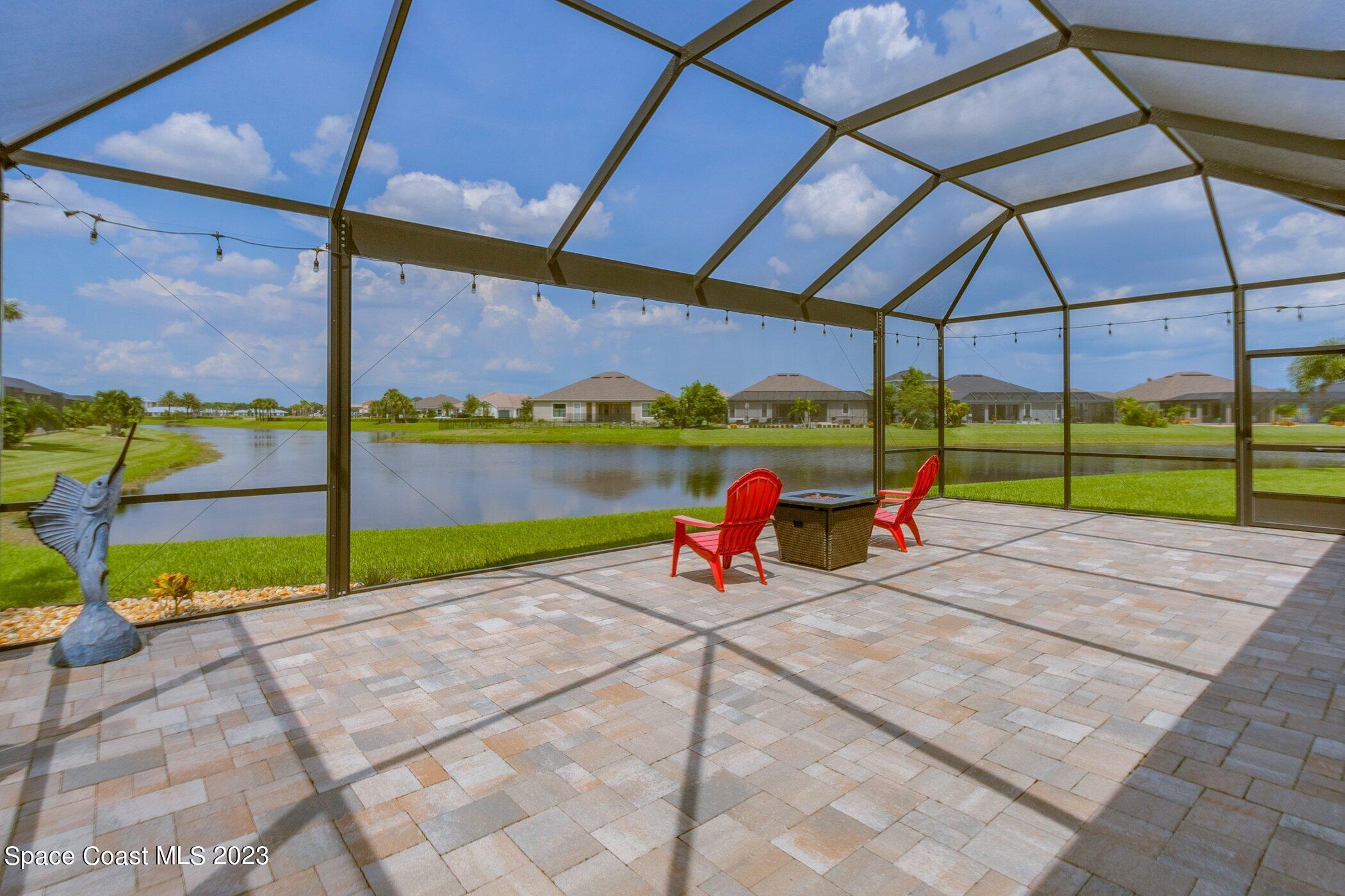 7729 Kerrington Drive Melbourne, FL 32940 - Photo 10 of 61 a view of a deck with a table and chairs under an umbrella