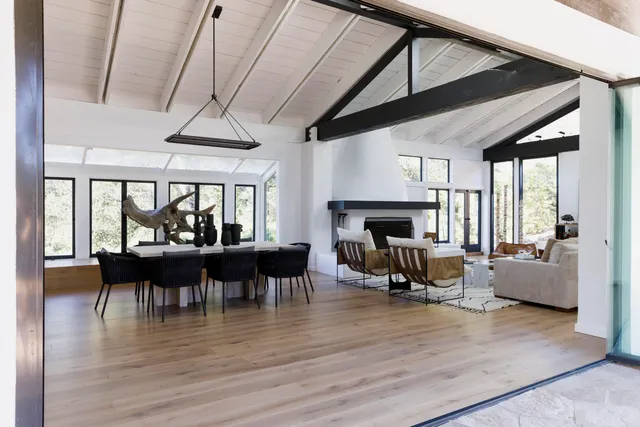 a living room with furniture a fireplace and wooden floor