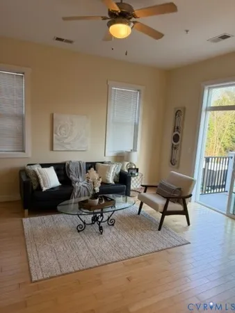 a living room with furniture rug and window