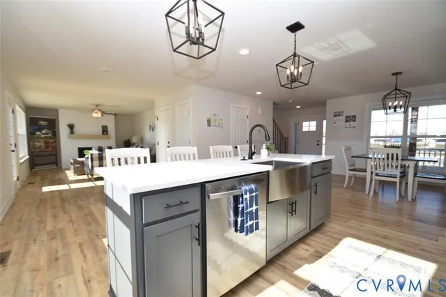 a kitchen with a counter space a sink appliances and cabinets