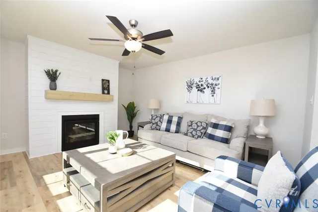 a living room with furniture and a fireplace