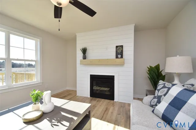 a living room with furniture fireplace and a window