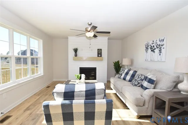 a living room with furniture a fireplace and a table
