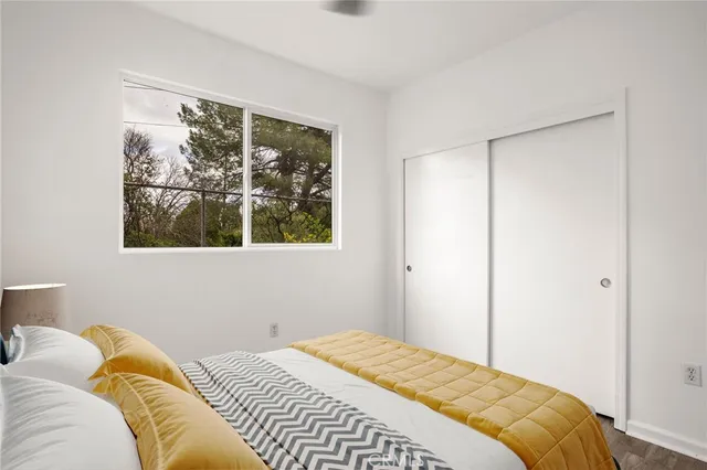 a bedroom with a bed and a window