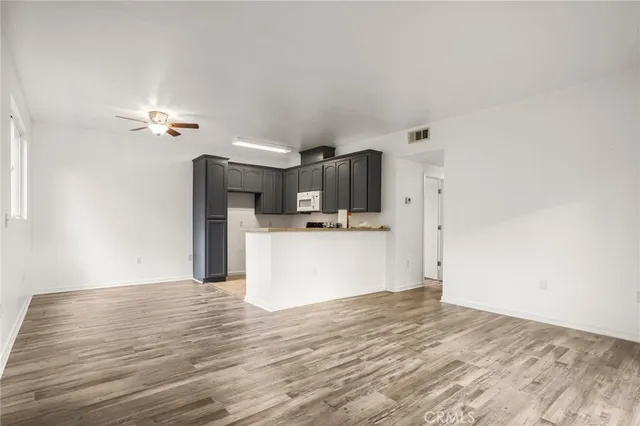 a view of a kitchen with wooden floor