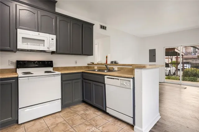 a kitchen with a sink stove and cabinets