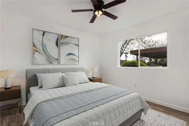 a bedroom with a bed and a painting on the wall