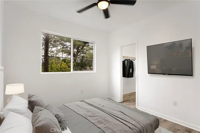 a bedroom with a bed and a television