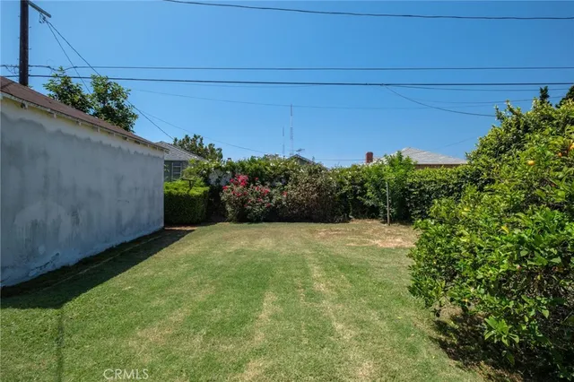 a view of a house with a yard and sitting area