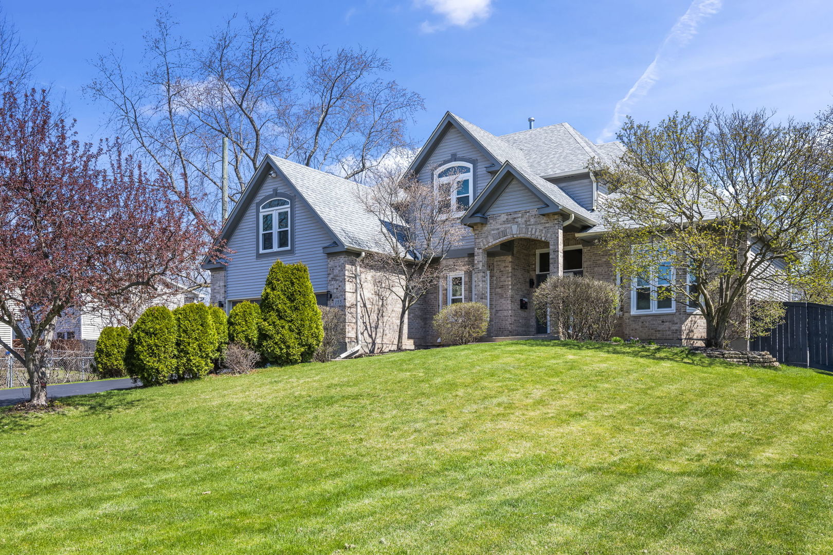 155 Lilac Lane Wheeling, IL 60090 - Photo 1 of 52 a front view of a house with a yard and garage