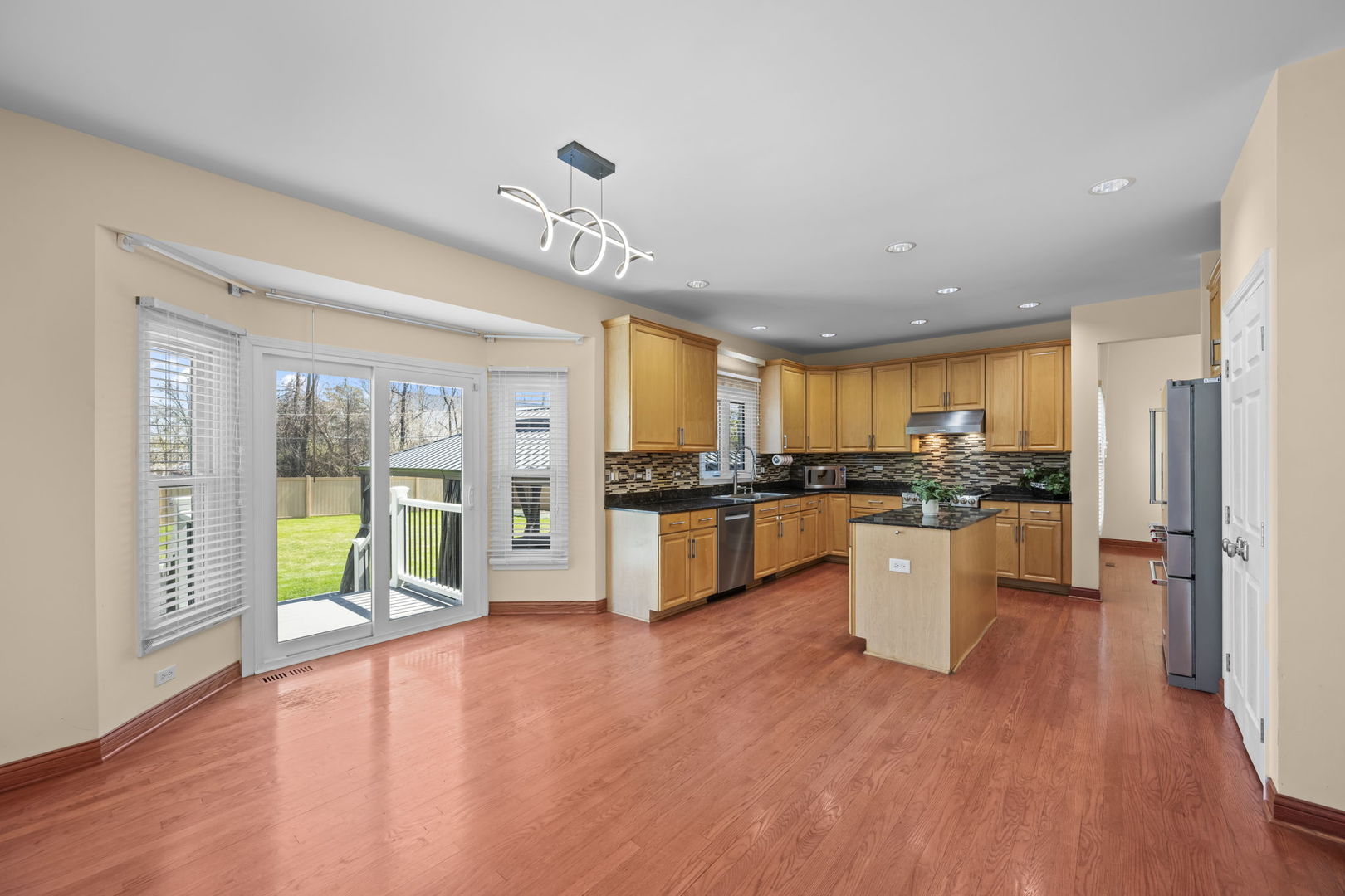 155 Lilac Lane Wheeling, IL 60090 - Photo 18 of 52 a large kitchen with stainless steel appliances granite countertop a large center island and a stove