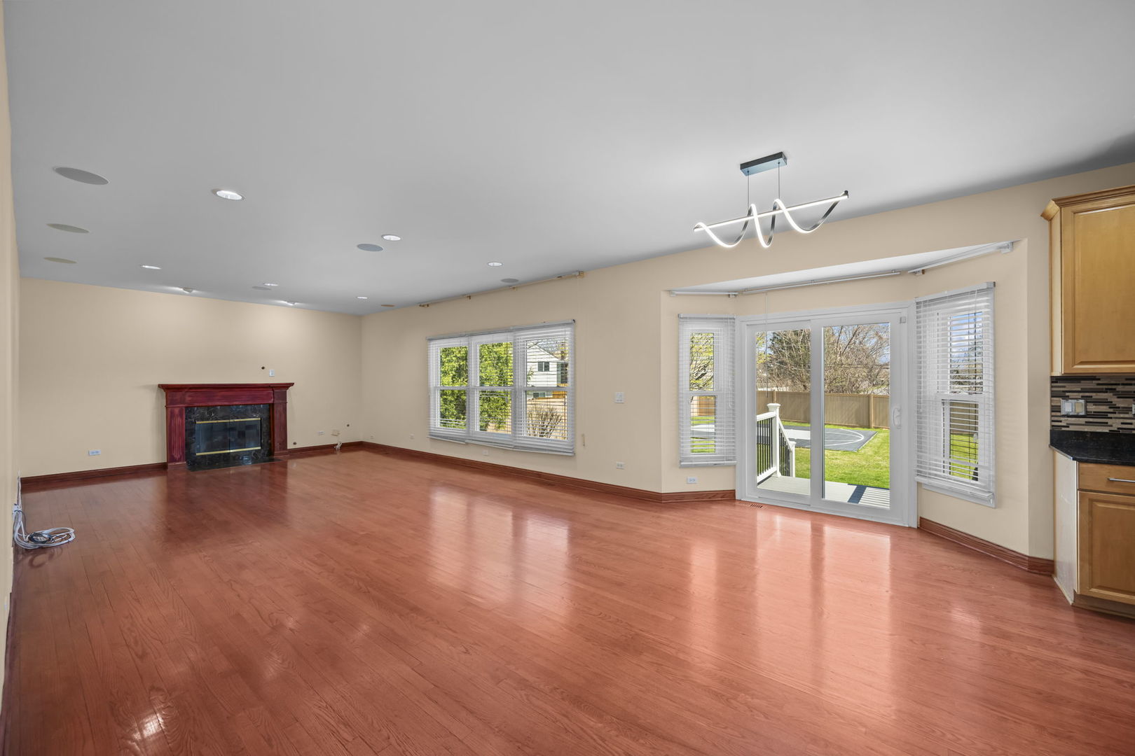 155 Lilac Lane Wheeling, IL 60090 - Photo 19 of 52 a view of an empty room with a window and wooden floor