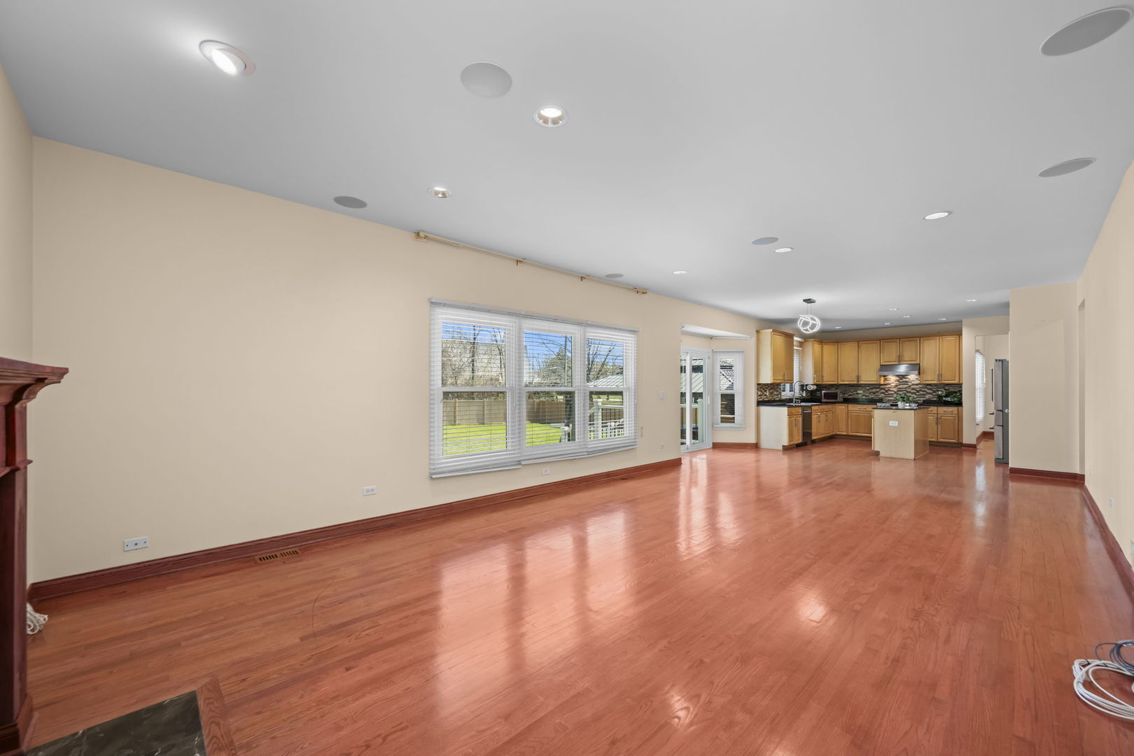 155 Lilac Lane Wheeling, IL 60090 - Photo 21 of 52 a view of an empty room with wooden floor and a window