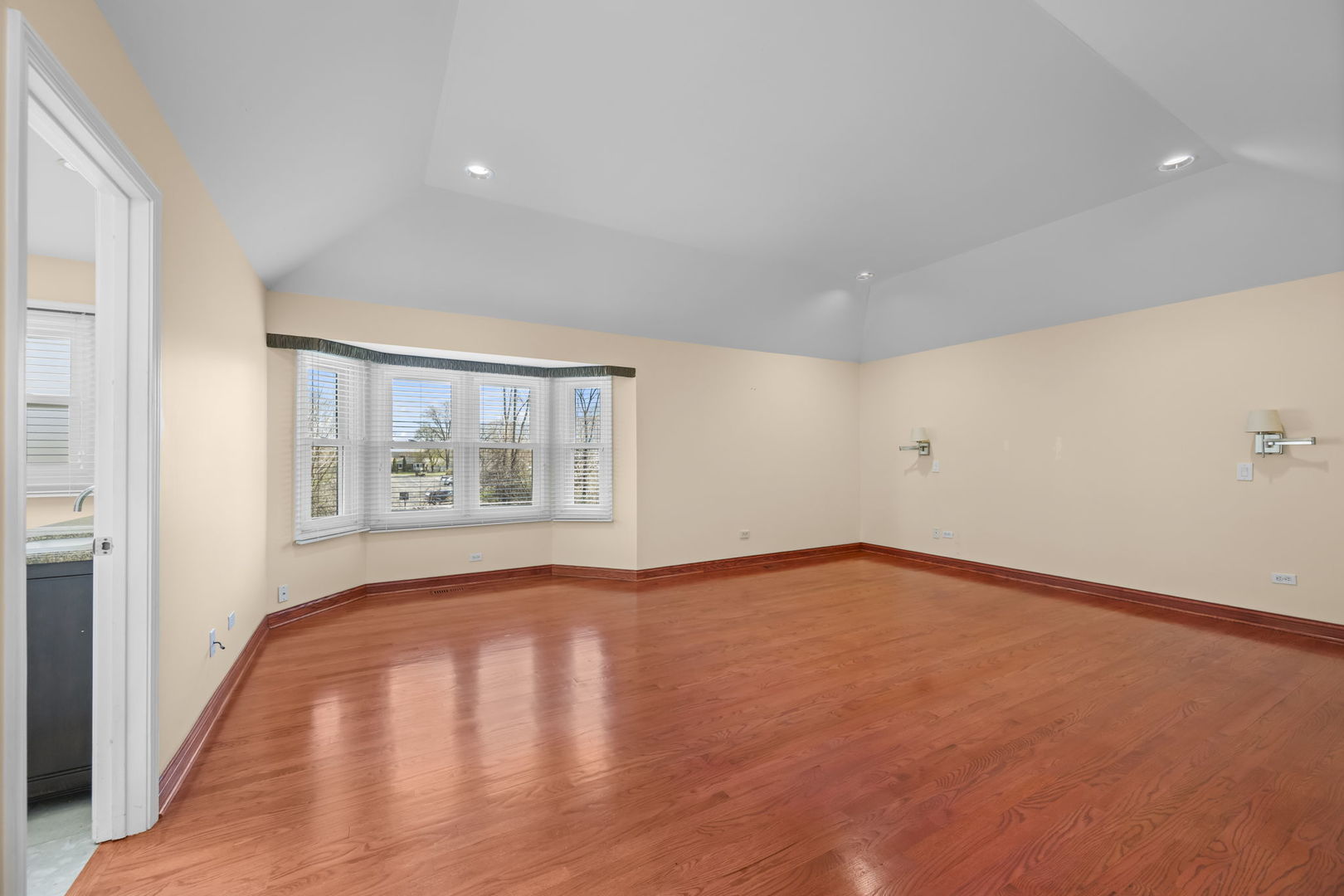 155 Lilac Lane Wheeling, IL 60090 - Photo 29 of 52 a view of an empty room with a window and wooden floor