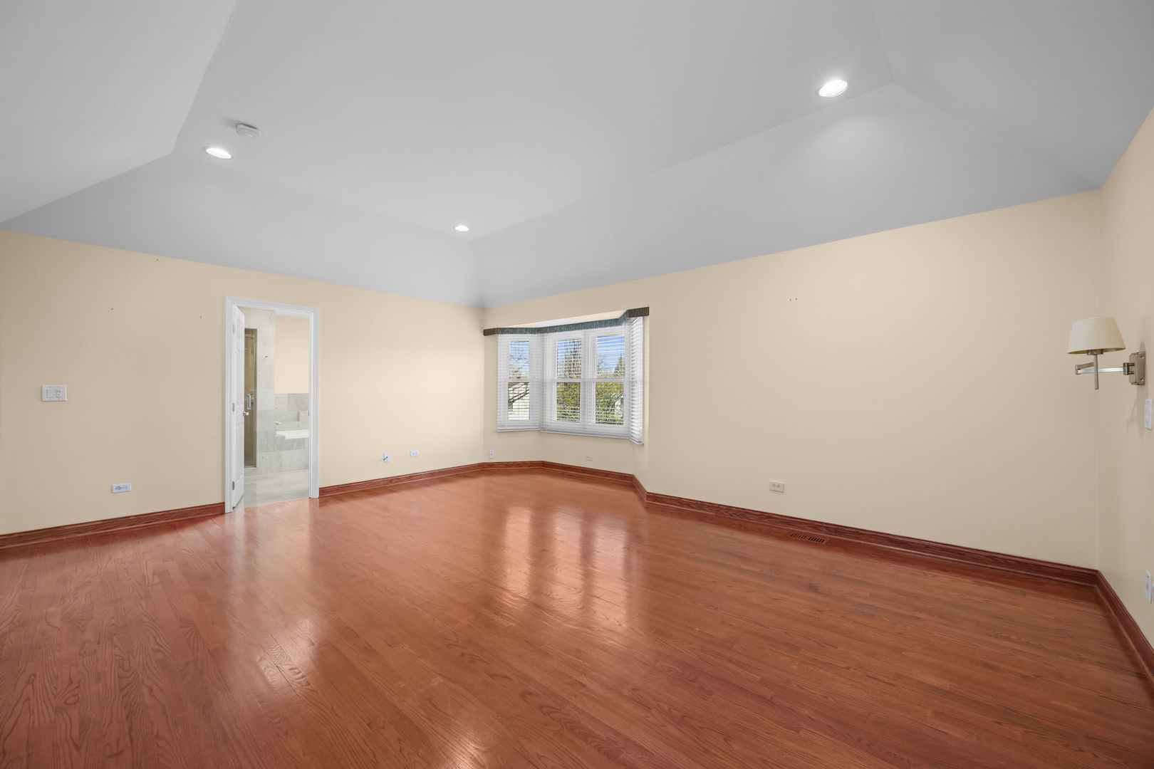 155 Lilac Lane Wheeling, IL 60090 - Photo 30 of 52 a view of an empty room with wooden floor and a window
