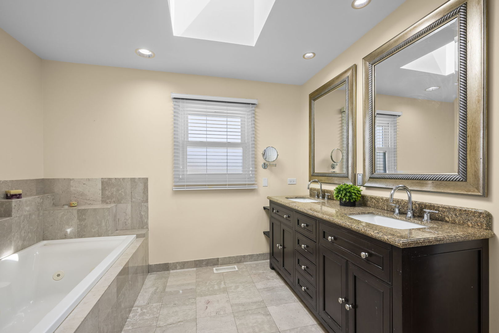 155 Lilac Lane Wheeling, IL 60090 - Photo 32 of 52 a bathroom with a double vanity sink large mirror and a bathtub