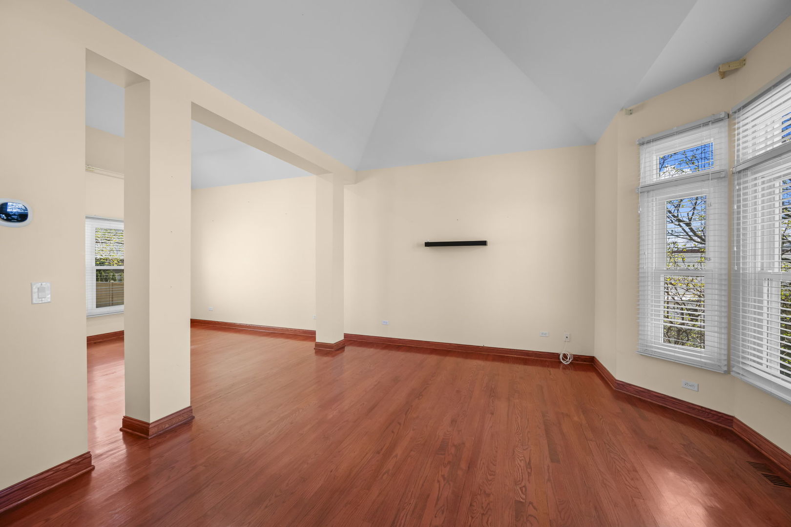 155 Lilac Lane Wheeling, IL 60090 - Photo 6 of 52 an empty room with wooden floor and windows