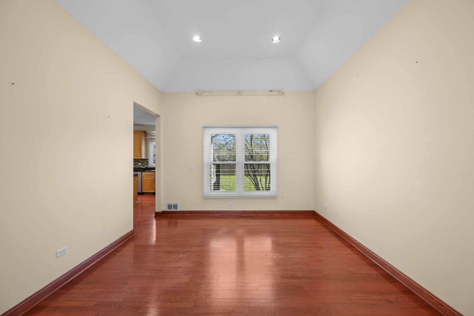 155 Lilac Lane Wheeling, IL 60090 - Photo 8 of 52 an empty room with wooden floor and windows