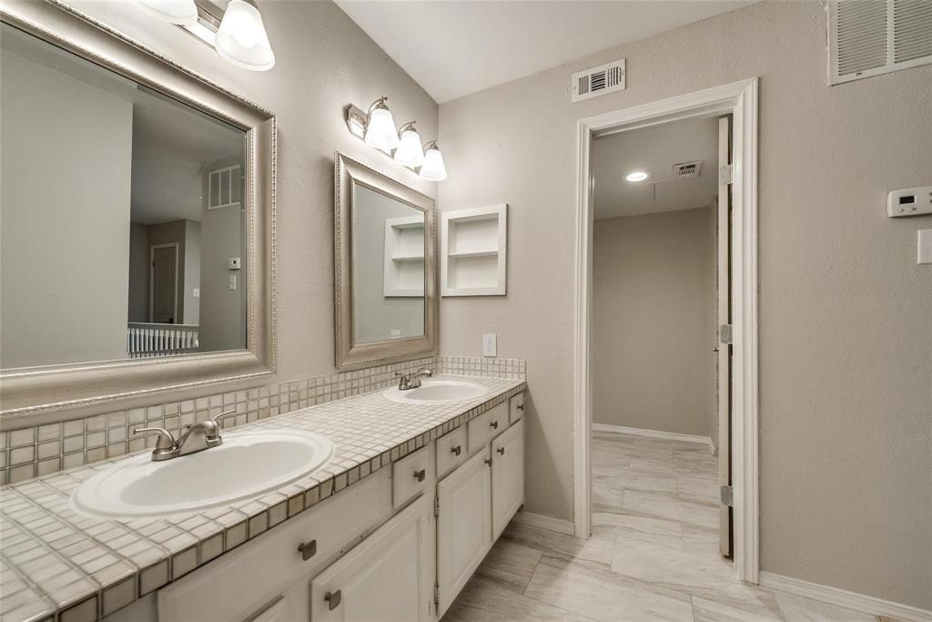 18240 Midway Road, Unit 302 Dallas, TX 75287 - Photo 25 of 33 a spacious bathroom with a double vanity sink and a mirror