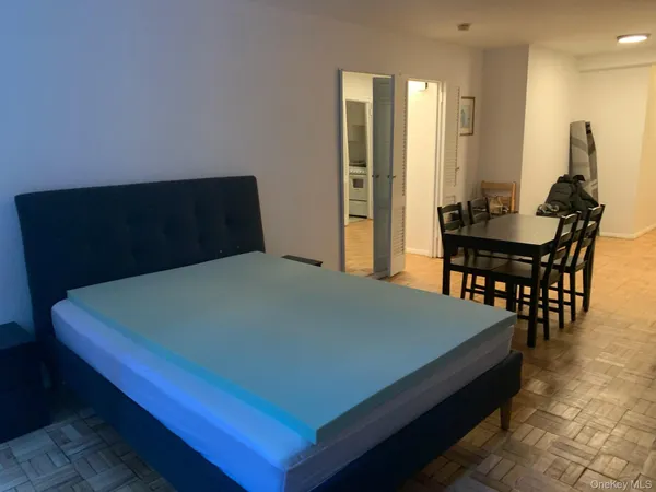 a bed sitting in a bedroom next to a window