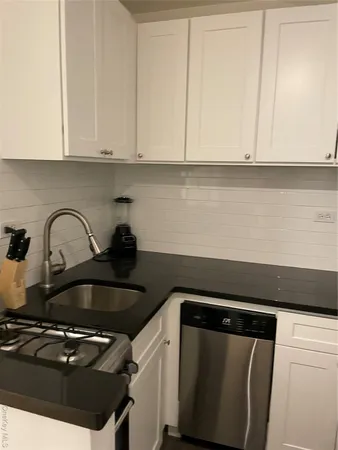 a close view of a stove top oven and cabinets