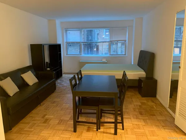 a dining room with furniture and window