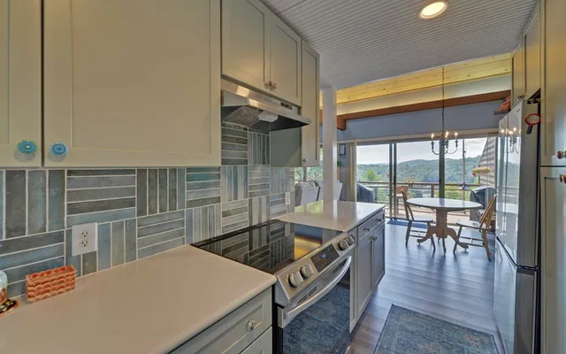 a view of a porch with furniture and wooden floor