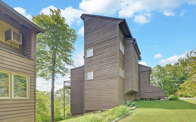 an aerial view of a house with outdoor space and a lake view
