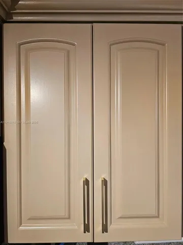 a view of a refrigerator in kitchen with wooden floor