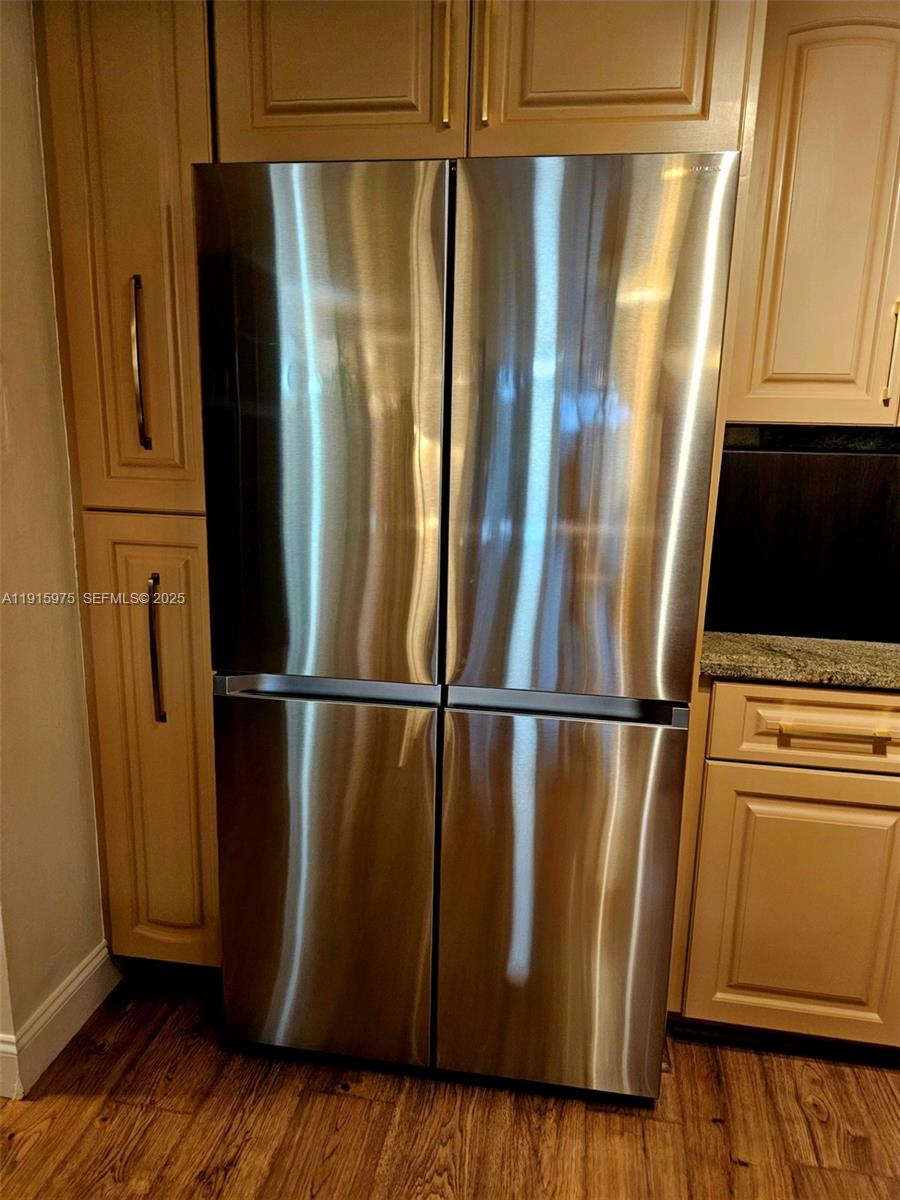 1800 North Andrews Avenue, Unit 2H Fort Lauderdale, FL 33311 - Photo 14 of 60 a view of a refrigerator in kitchen with wooden floor