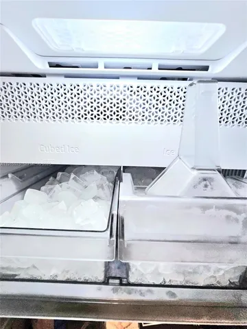 a living room with furniture rug and kitchen view