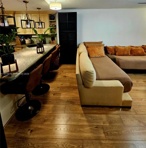 a view of a balcony with wooden floor and furniture