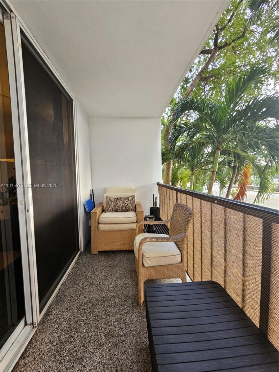 1800 North Andrews Avenue, Unit 2H Fort Lauderdale, FL 33311 - Photo 27 of 60 a view of a balcony with wooden floor and furniture