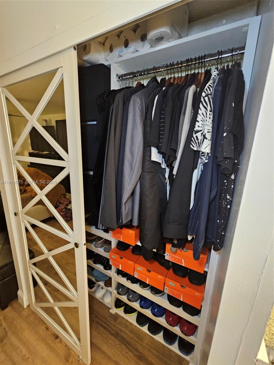 1800 North Andrews Avenue, Unit 2H Fort Lauderdale, FL 33311 - Photo 30 of 60 a view of walk in closet with clothes and shoes