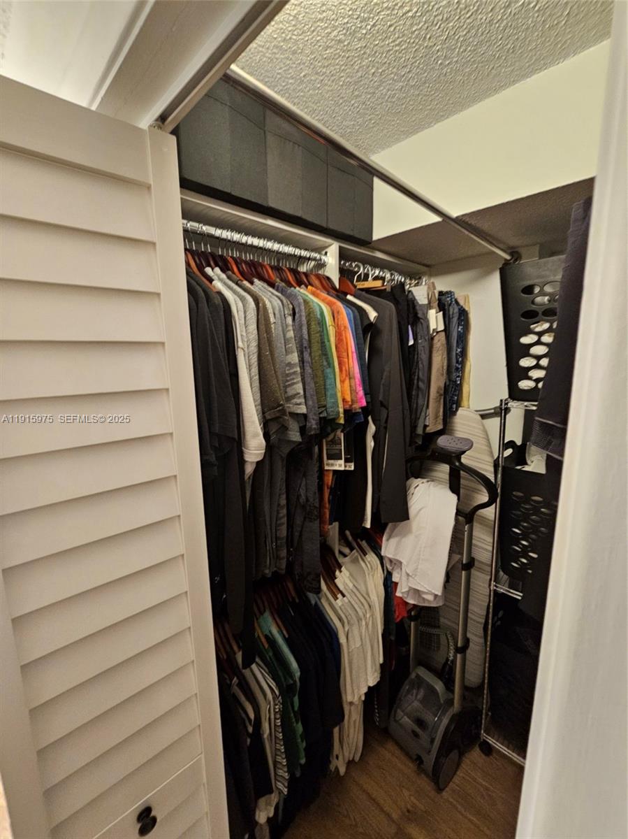 1800 North Andrews Avenue, Unit 2H Fort Lauderdale, FL 33311 - Photo 33 of 60 a view of walk in closet with clothes and shoes
