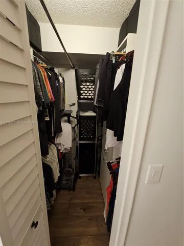 a bathroom with a shower curtain and sink