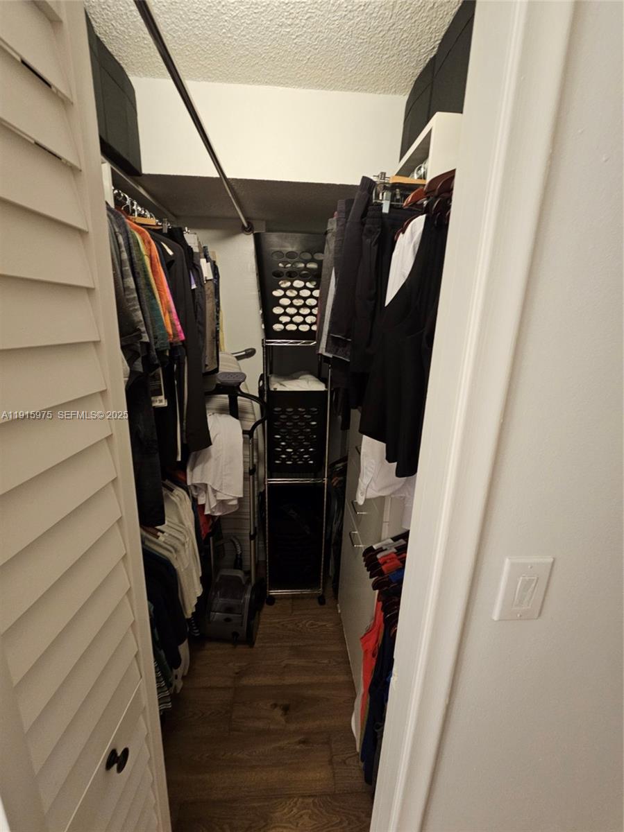1800 North Andrews Avenue, Unit 2H Fort Lauderdale, FL 33311 - Photo 34 of 60 a view of walk in closet with clothes and shoes