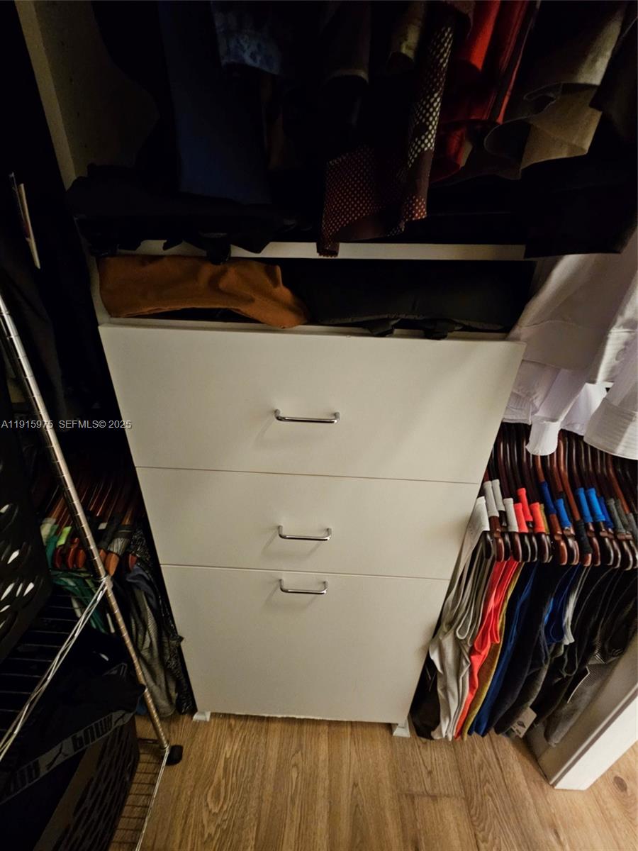 1800 North Andrews Avenue, Unit 2H Fort Lauderdale, FL 33311 - Photo 35 of 60 a view of walk in closet with clothes and shoes