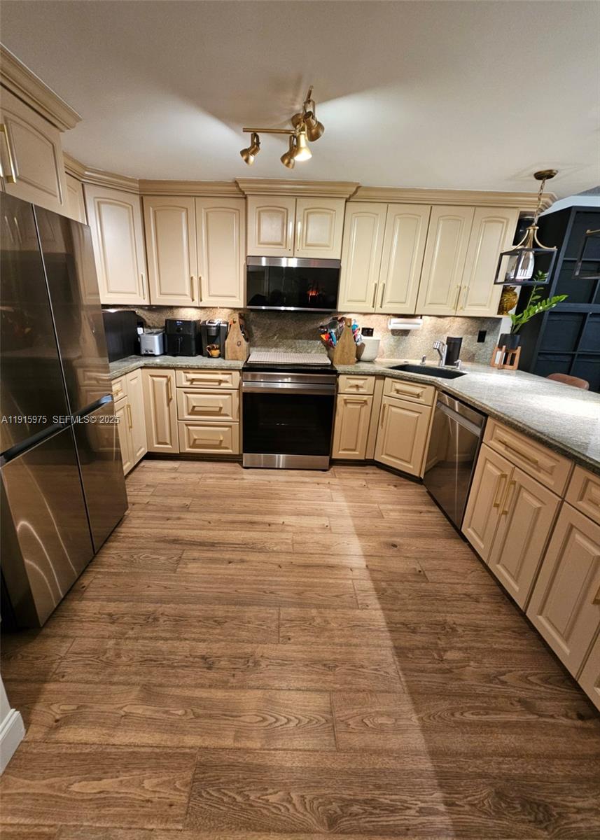 1800 North Andrews Avenue, Unit 2H Fort Lauderdale, FL 33311 - Photo 4 of 60 a kitchen with granite countertop a refrigerator stove top oven and sink