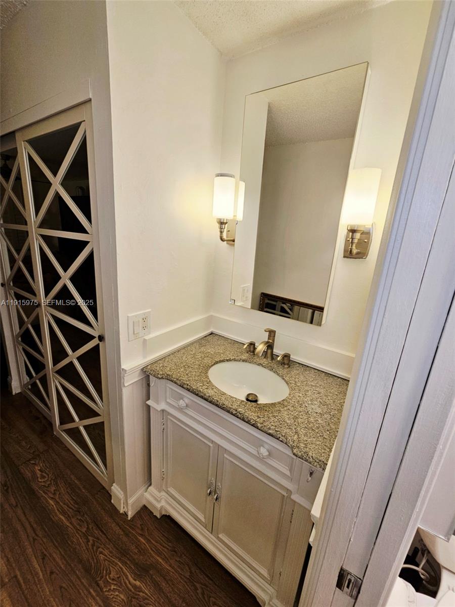 1800 North Andrews Avenue, Unit 2H Fort Lauderdale, FL 33311 - Photo 46 of 60 a bathroom with a granite countertop sink and a mirror