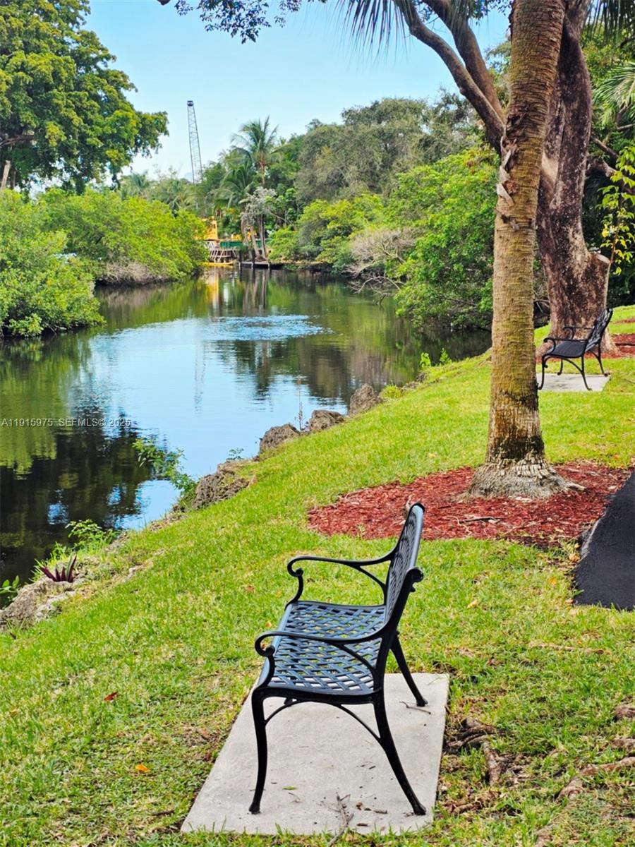 1800 North Andrews Avenue, Unit 2H Fort Lauderdale, FL 33311 - Photo 55 of 60 a wooden bench sitting in the middle of a lake