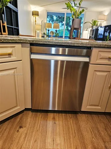 a kitchen with stainless steel appliances wooden cabinets a refrigerator and a sink