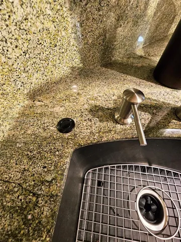 a stove top oven sitting inside of a kitchen